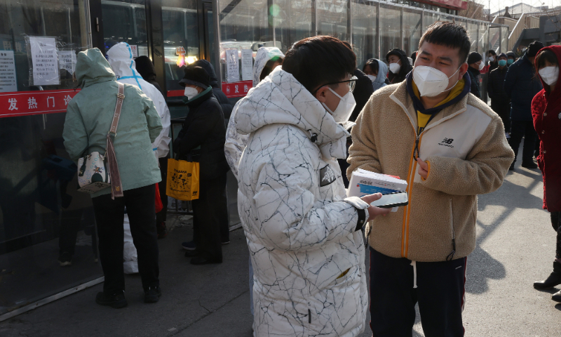 People wait for treatment outside the fever clinic of Tongzhou Luhe Hospital on December 9, 2022. Photo: VCG