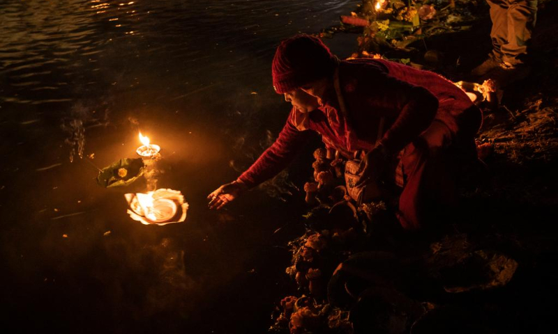People float oil lamps as a tradition to observe the Bala Chaturdashi Festival in Kathmandu, Nepal, Nov. 22, 2022. (Photo by Hari Maharjan/Xinhua)