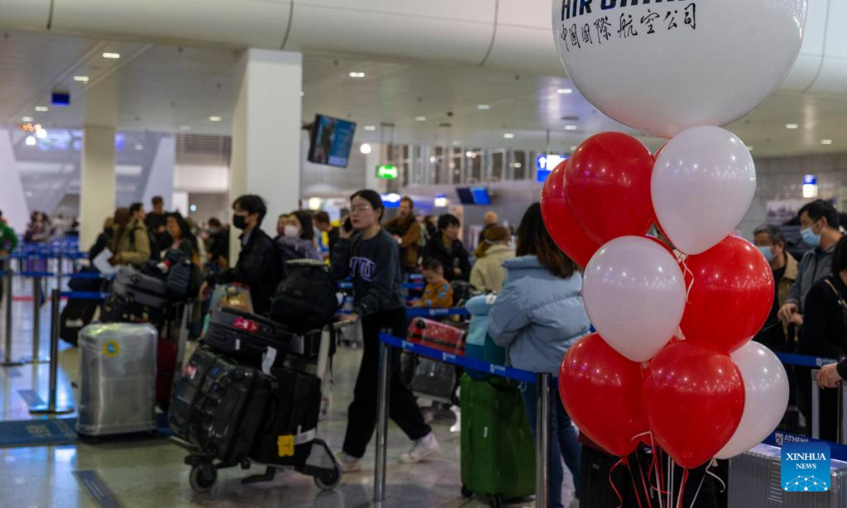 Passengers wait to check in for the first direct flight between Shanghai and Athens at Athens International Airport, Greece, on Dec 22, 2022. Photo:Xinhua