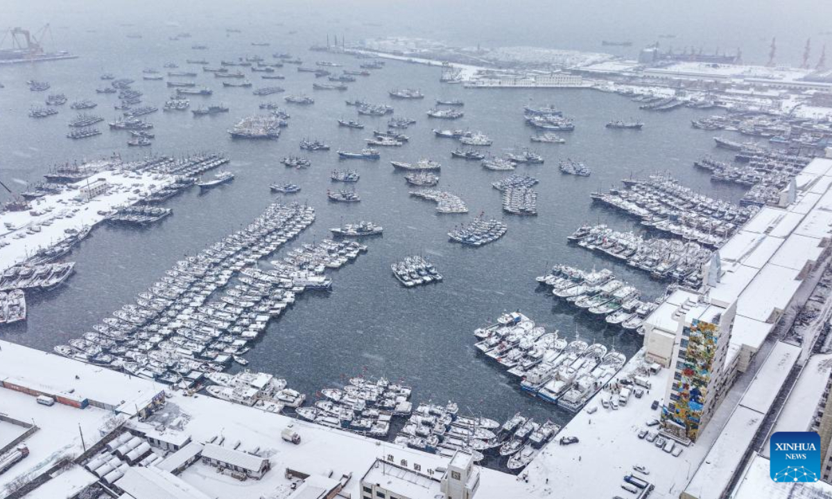 This aerial photo taken on Dec 22, 2022 shows fishing boats berthing in the snow at Shidao fishing port in Rongcheng, east China's Shandong Province. Photo:Xinhua