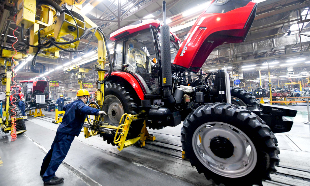 Wokers assemble tractors for export in Luoyang, Central China's Henan Province. Photo: VCG