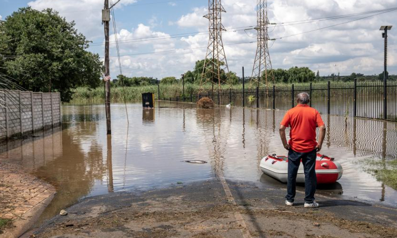 A man stands in a flooded area after heavy rain in Johannesburg, South Africa, Dec. 9, 2022. (Photo by Shiraaz Mohamed/Xinhua)