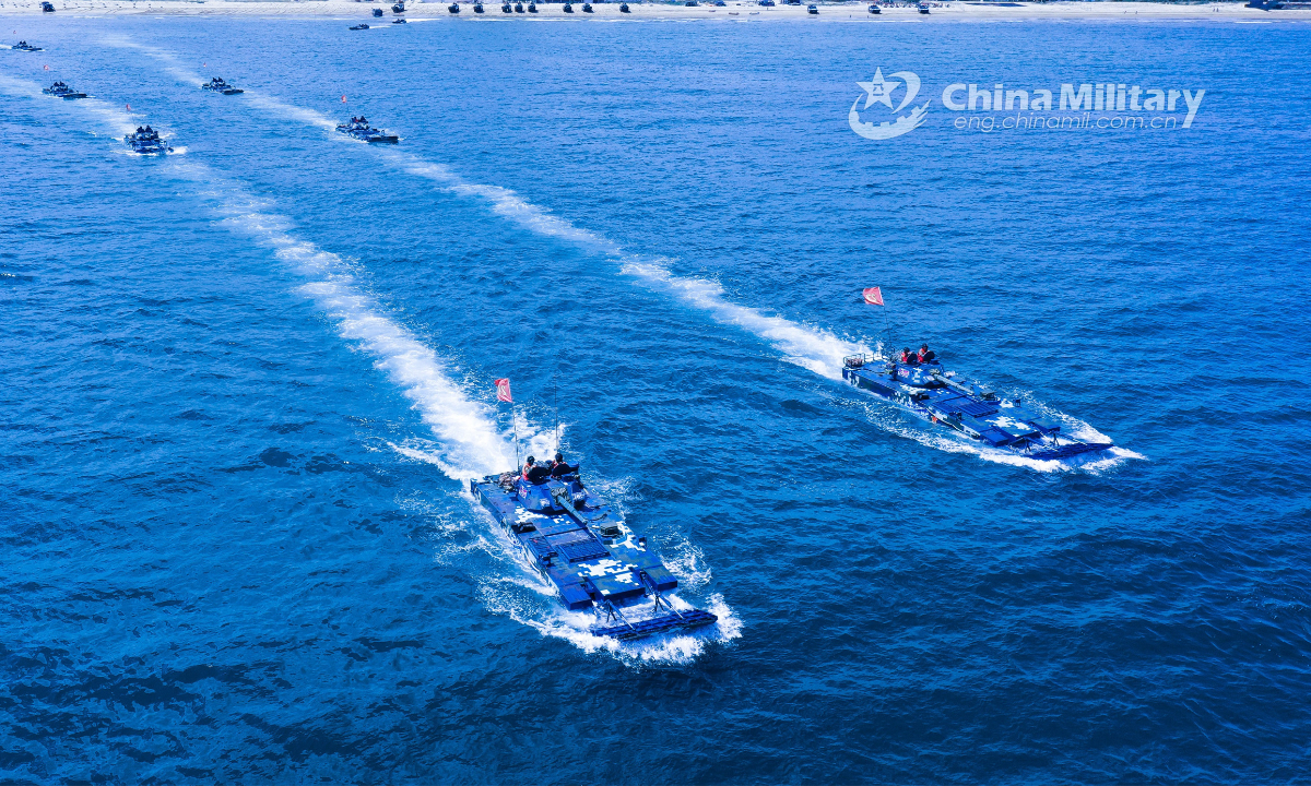 Amphibious armored vehicles attached to a brigade of the PLA Navy's Marine Corps make their way to the beach-head in assault wave formation during a maritime offense and defense training exercise recently. Photo:China Military