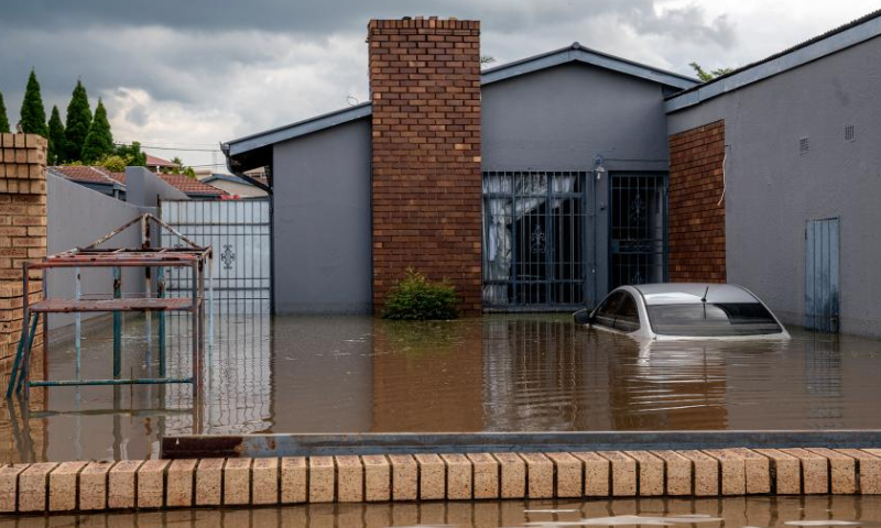 A car is submerged in a flooded area after heavy rain in Johannesburg, South Africa, Dec. 9, 2022. (Photo by Shiraaz Mohamed/Xinhua)