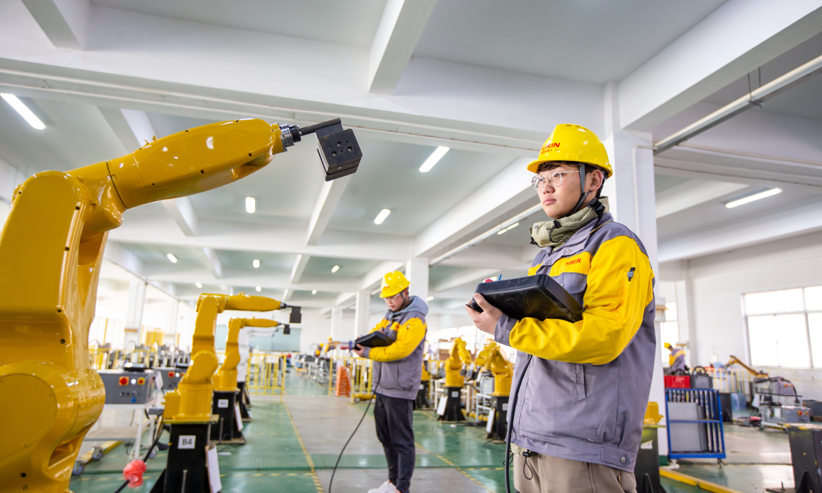 Workers test and adjust machineries at a plant in Hai'an, East China's Jiangsu Province on December 12, 2022. Photo: cnsphoto