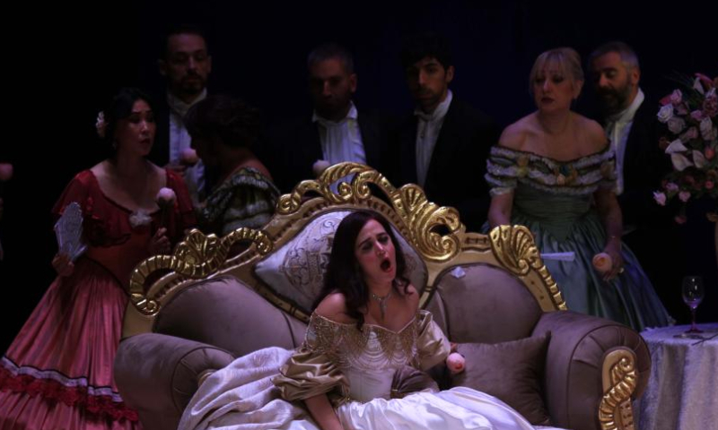 Soprano Zeina Barhoum (Front) performs in the opera La Traviata during the 2022 Amman Opera Festival in Amman, Jordan, on Nov. 18, 2022. (Photo by Mohammad Abu Ghosh/Xinhua)