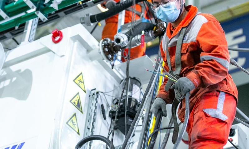 An employee works on a tunnel boring machine at a workshop of China Railway Engineering Equipment Group Co., Ltd. (CREG) in Zhengzhou, central China's Henan Province, Nov. 24, 2022. Tunnel boring machines made by CREG have been exported to more than 30 countries and regions for major projects, which are actively serving tunnel construction projects globally. (Xinhua)
