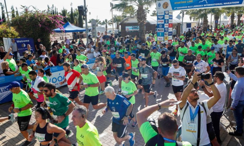 Participants run during the Larnaca International Marathon in Larnaca, Cyprus, Nov. 20, 2022. (Photo by George Christophorou/Xinhua)