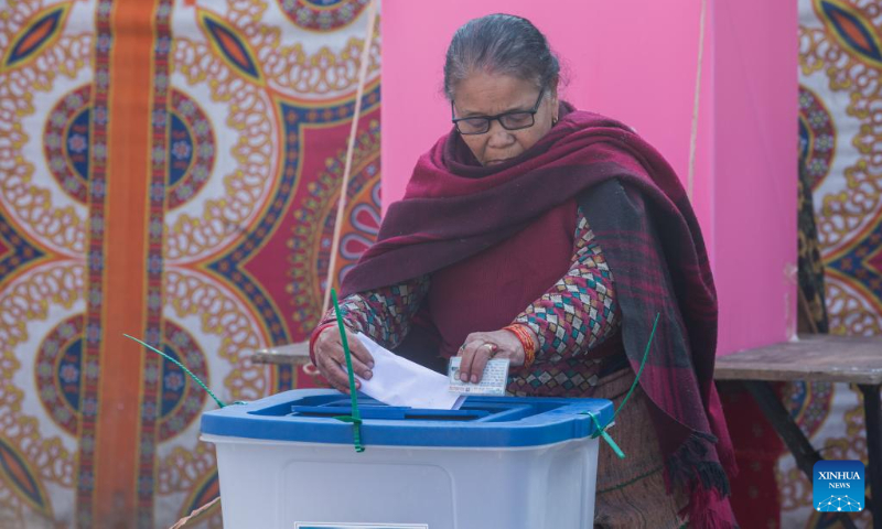 A woman casts her ballot during the general elections in Lalitpur, Nepal, Nov. 20, 2022. Nepalis went to the polls on Sunday morning for elections to the House of Representatives of the federal parliament and seven provincial assemblies. (Photo by Hari Maharjan/Xinhua)