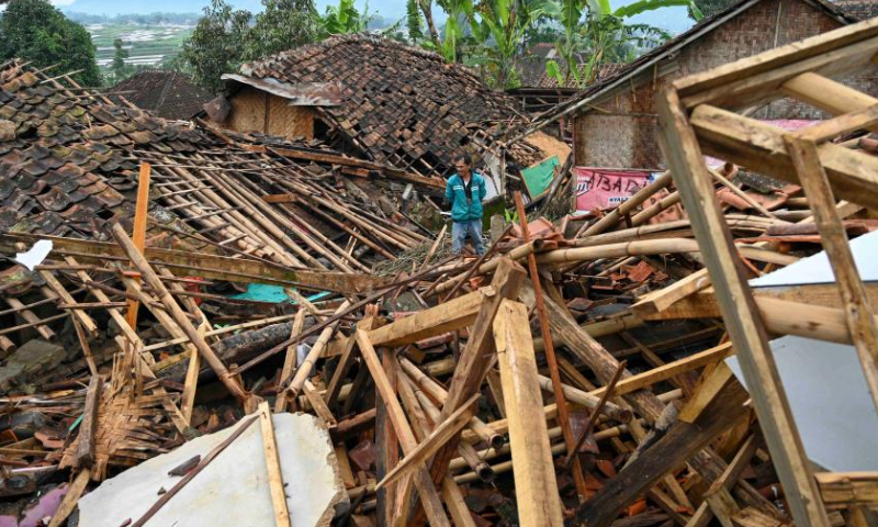 A villager stands amid debris of destroyed houses in Cianjur, West Java, Indonesia, Nov. 26, 2022. The death toll of the 5.6-magnitude earthquake hitting Indonesia's West Java province increased to 310, and 24 others were still missing, an official said on Friday. (Xinhua/Zulkarnain)