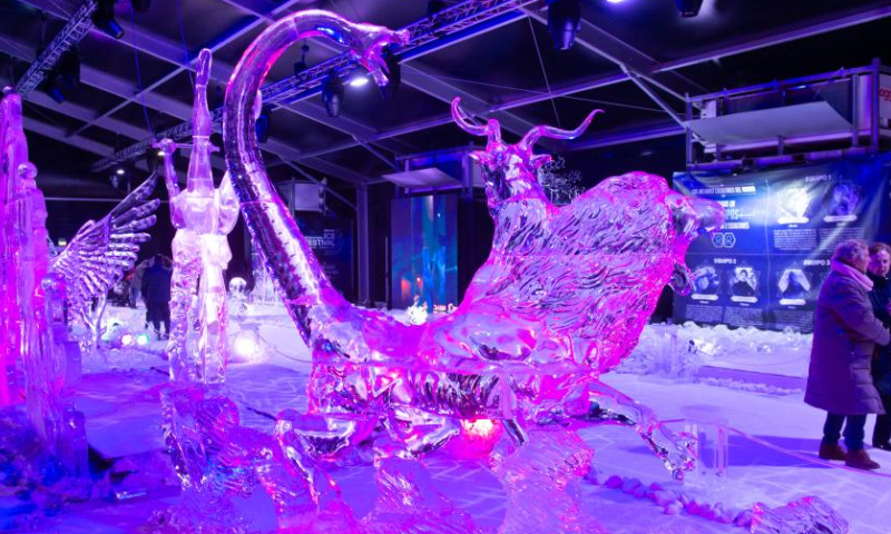 Visitors enjoy the ice sculptures on display at the Ice Festival in Torrejon de Ardoz, Madrid, Spain, on Dec. 15, 2022. (Photo by Gustavo Valiente/Xinhua)