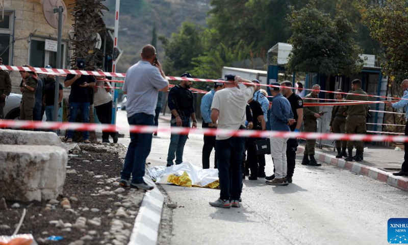 People gather at the scene of an attack near the Israeli settlement of Ariel in the West Bank, on Nov. 15, 2022. A Palestinian man killed three Israelis and wounded three others in an attack on Tuesday in the West Bank before being shot dead by Israeli forces, Israeli military and medics said. Photo: Xinhua