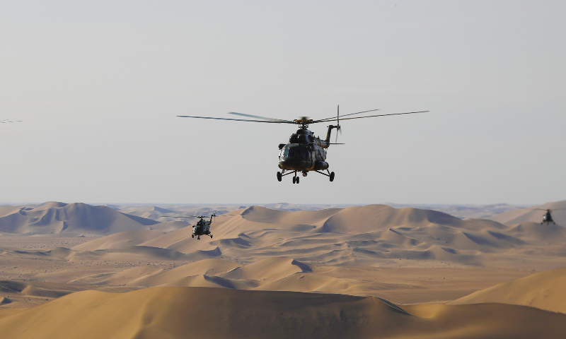 Transport helicopters attached to an army aviation brigade of the PLA 81st Group Army fly over the desert during a flight training exercise on December 1, 2022. (eng.chinamil.com.cn/Photo by Chen Kai)