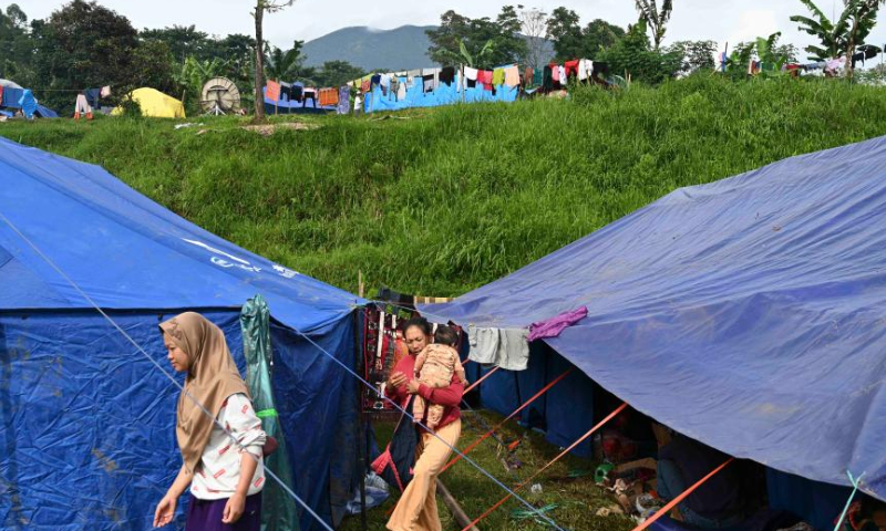 Villagers are seen near makeshift tents at a temporary shelter in Cianjur, West Java, Indonesia, Nov. 26, 2022. The death toll of the 5.6-magnitude earthquake hitting Indonesia's West Java province increased to 310, and 24 others were still missing, an official said on Friday. (Xinhua/Zulkarnain)