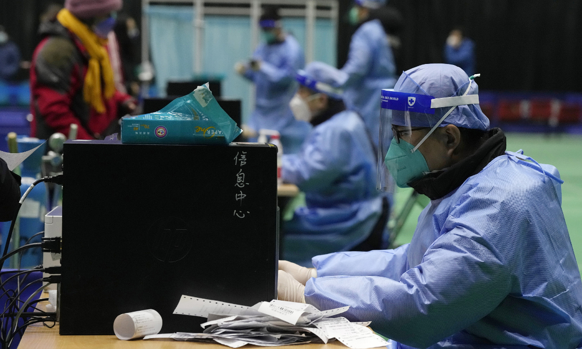 Medical workers attend to visitors at a fever clinic converted from a gymnasium in Beijing on December 17, 2022. Photo: VCG