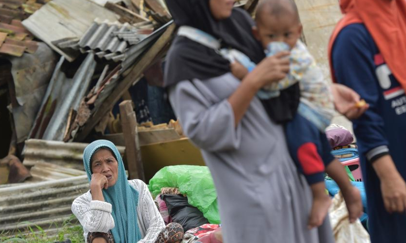 Residents are seen in front of damaged houses at Mangunkerta village in Cianjur, West Java, Indonesia, Nov. 24, 2022. The strong quake striking West Java province on Monday displaced 62,545 residents in Cianjur district, one of the hardest-hit areas, and a total of 14 evacuation centers have been established, head of the National Disaster Management Agency Suharyanto said on Thursday. (Xinhua/Veri Sanovri)