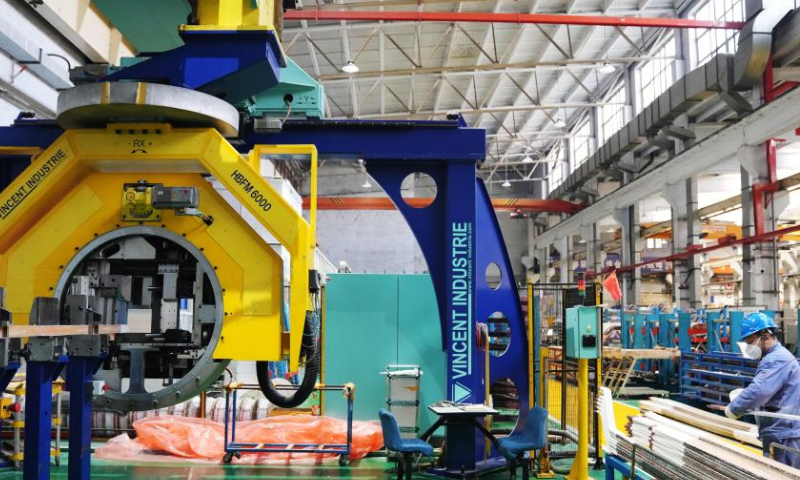 A staff worker works in the factory of Harbin Electric Corporation in Harbin, northeast China's Heilongjiang Province, Nov. 17, 2022. Harbin Electric Corporation, a leading Chinese electric machinery maker in northeast China's Heilongjiang Province, has accelerated digitalization to promote smart production in recent years. (Xinhua/Wang Jianwei)