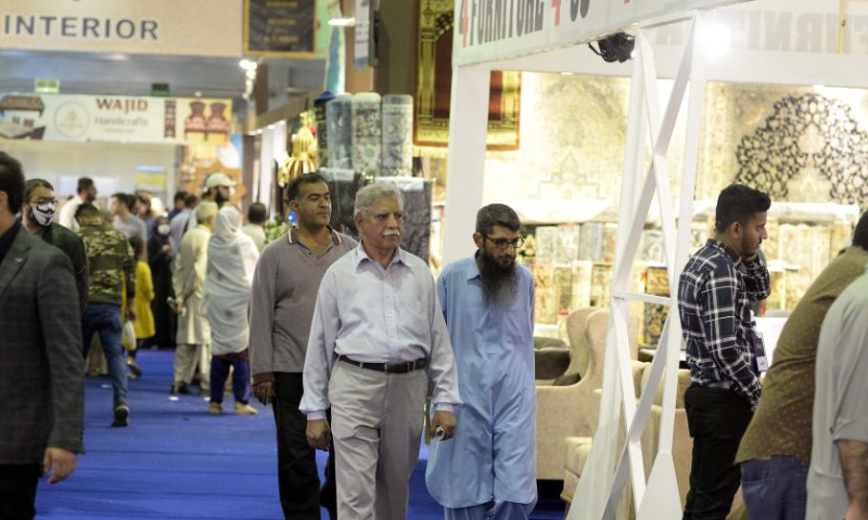 People visit a lifestyle and furniture expo in southern Pakistani port city of Karachi on Dec. 11, 2022. A three-day furniture and living expo ends in Karachi on Sunday, showcasing a vast range of home and office furniture, decorative accessories, massagers and fitness machines, rugs and carpets. (Xinhua/Ahmad Kamal)