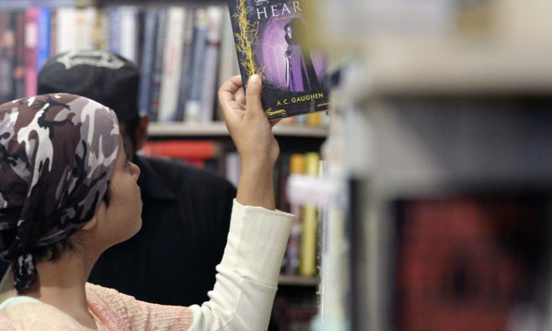 A woman picks a book at a stall at the Karachi International Book Fair in Karachi, Pakistan on Dec. 11, 2022.

Over 300 bookstalls have been set up in the book fair, which will conclude on Monday. (Xinhua/Ahmad Kamal)