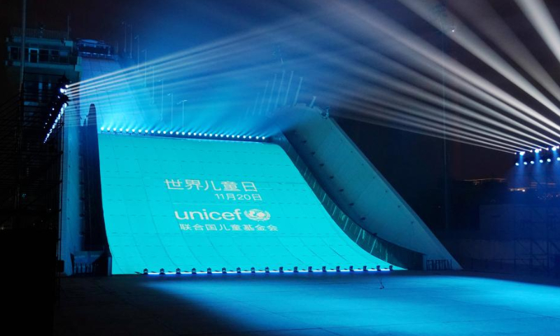 Shougang ski jumping platform is lit up to celebrate World Children's Day in Beijing, capital of China, Nov. 20, 2022. (Xinhua/Zhang Chenlin)