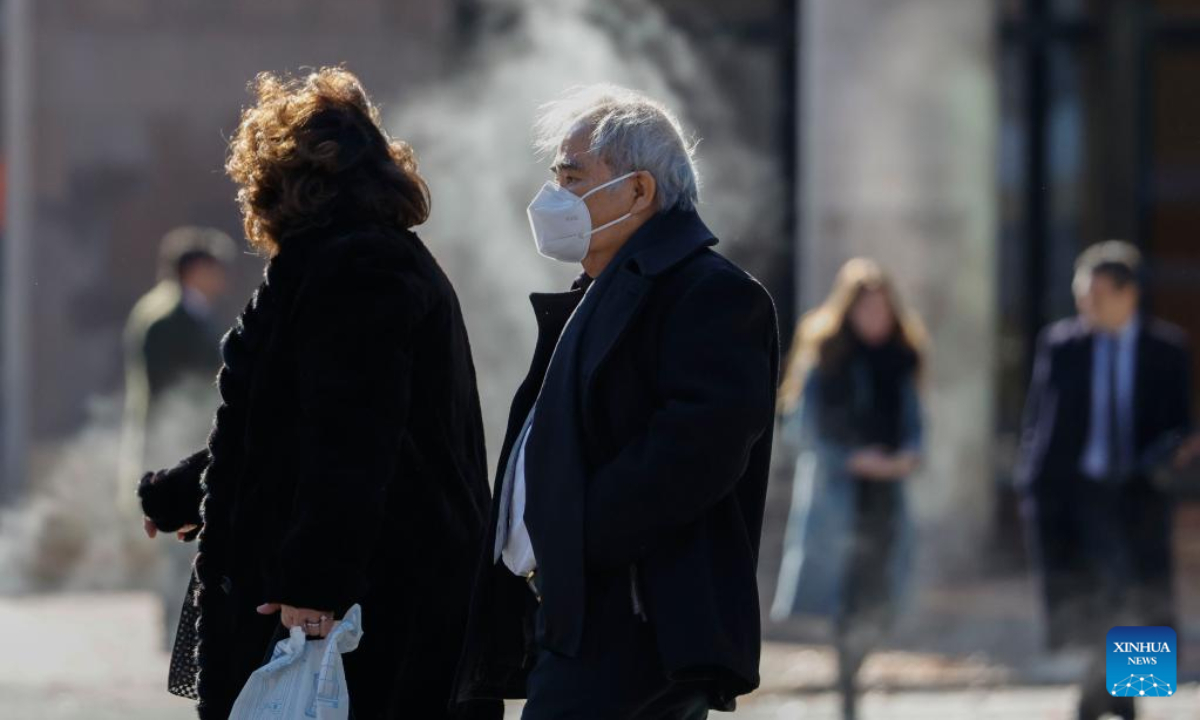 A man wearing a face mask is seen on a street in Washington, DC, the United States, on Dec 16, 2022. Photo:Xinhua