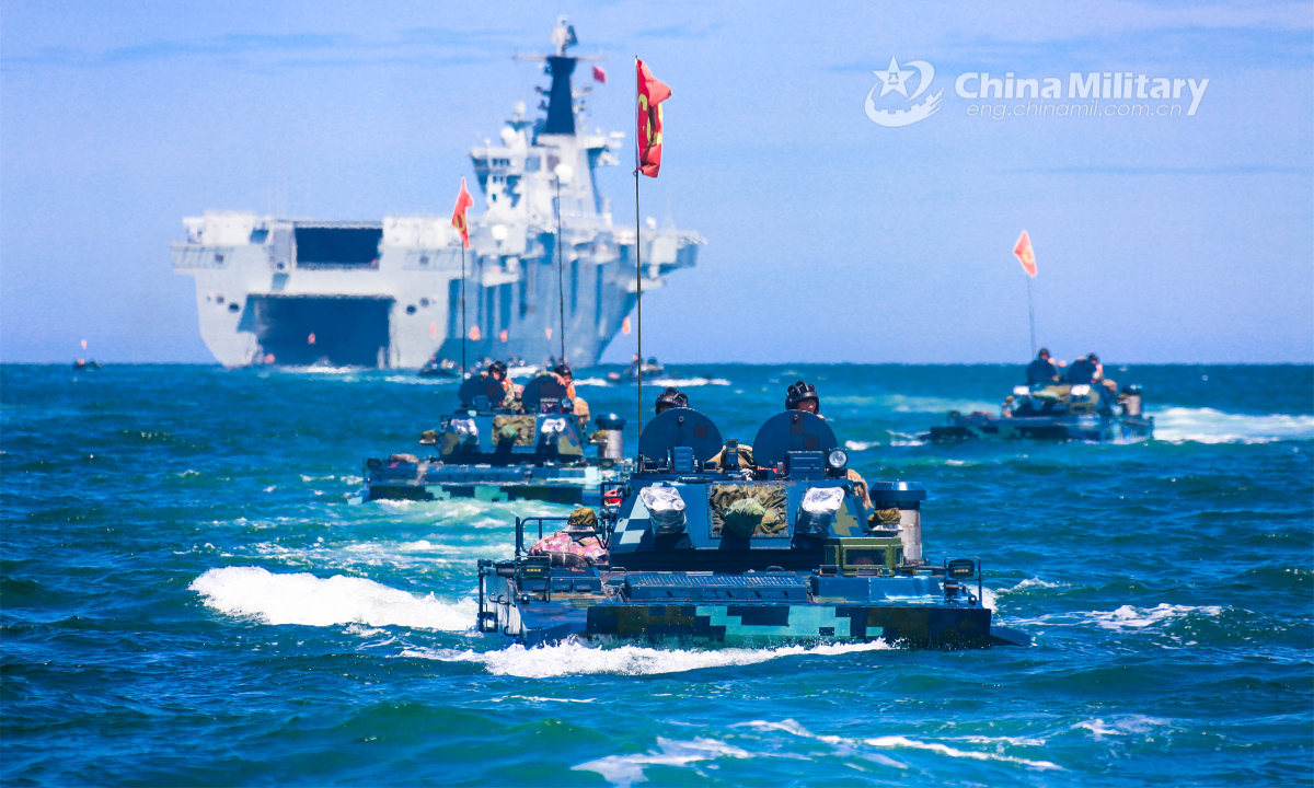 Amphibious armored vehicles attached to a brigade of the PLA Navy's Marine Corps make their way to the beach-head during a maritime offense and defense training exercise recently. Photo:China Military
