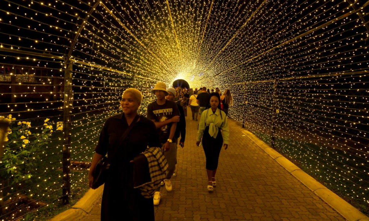 People walk through a light tunnel at a light fair in Potchefstroom, South Africa, Dec 22, 2022. Photo:Xinhua