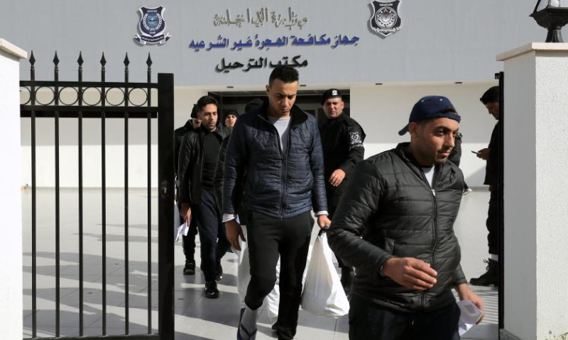 Illegal migrants walk out of the Deportation Office of the Anti-illegal Immigration Department in Tripoli, Libya, on Nov. 24, 2022. The Libyan Anti-illegal Immigration Department on Thursday deported more than 200 illegal migrants to their countries of origin. (Photo by Hamza Turkia/Xinhua)