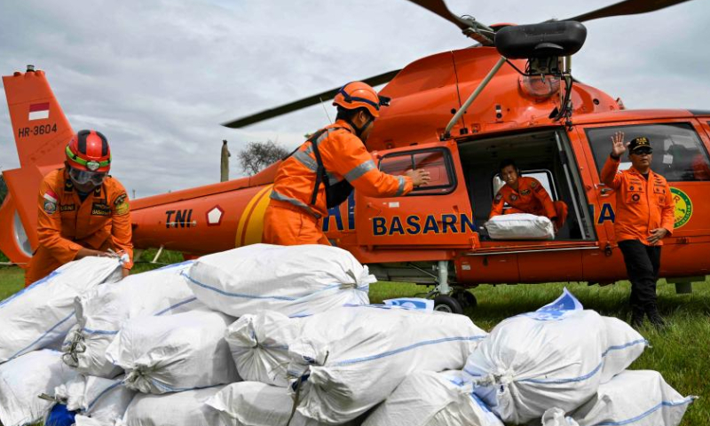 Members of Indonesian National Search and Rescue Agency unload relief supplies in Cianjur, West Java, Indonesia, Nov. 26, 2022. The death toll of the 5.6-magnitude earthquake hitting Indonesia's West Java province increased to 310, and 24 others were still missing, an official said on Friday. (Xinhua/Zulkarnain)