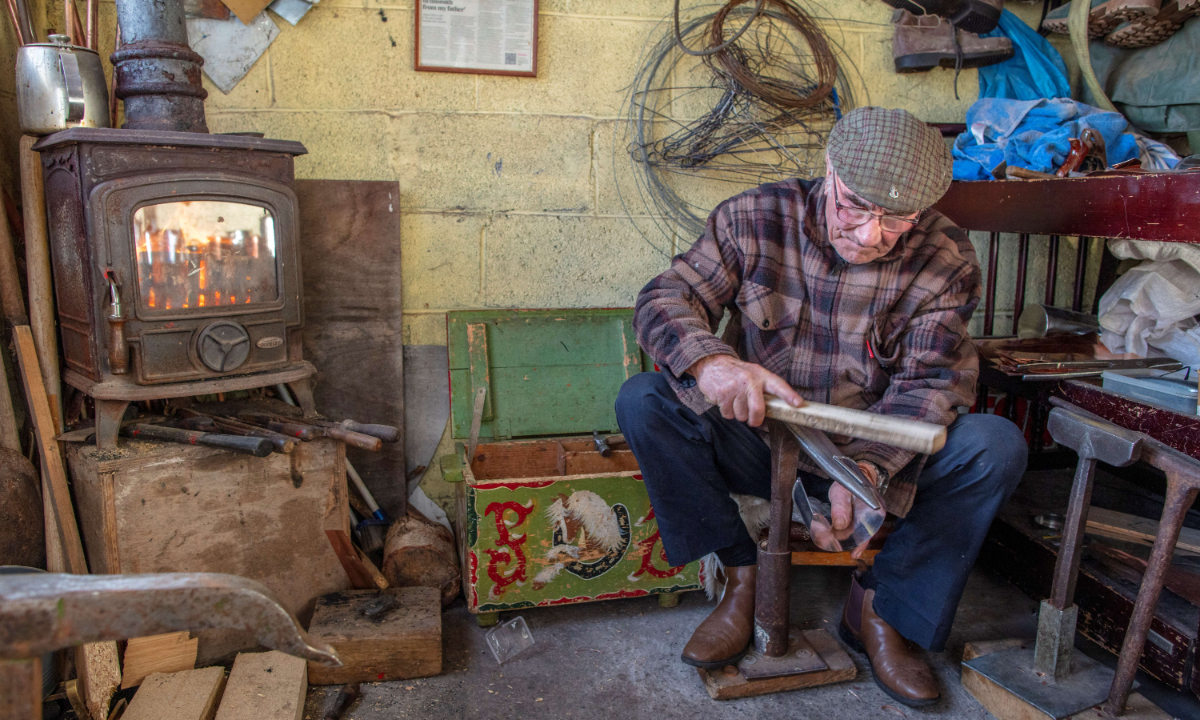 James Collins, one of the last remaining traditional Traveler tinsmiths in Ireland, works at his workshop in Finglas, Dublin. File photos: AFP
