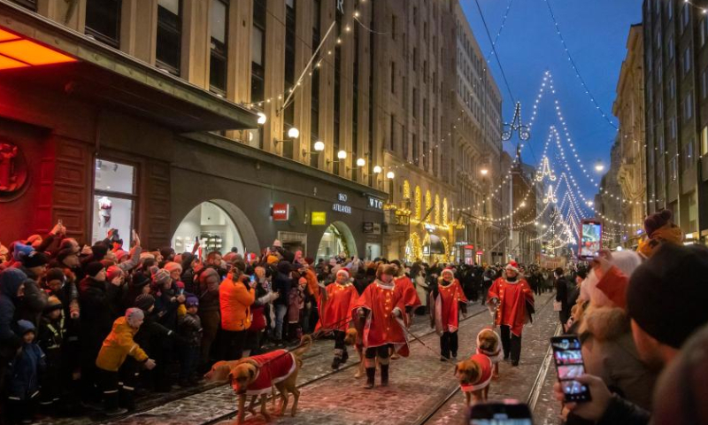 People participate in the Christmas opening celebration in Helsinki, Finland, Nov. 19, 2022. The Christmas opening celebration was held in central Helsinki on Saturday with a glittering parade, marking the start of the festive season. (Photo by Matti Matikainen/Xinhua)
