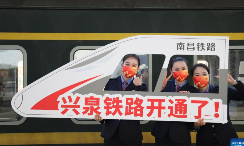 Railway staff pose for a photo at Quanzhou railway station in Quanzhou, southeast China's Fujian Province, Dec. 30, 2022. The 464-km railway linking Xingguo in east China's Jiangxi Province and Quanzhou in southeast China's Fujian Province, started operation on Friday. The designed speed of the line is 160 km/h. Photo: Xinhua