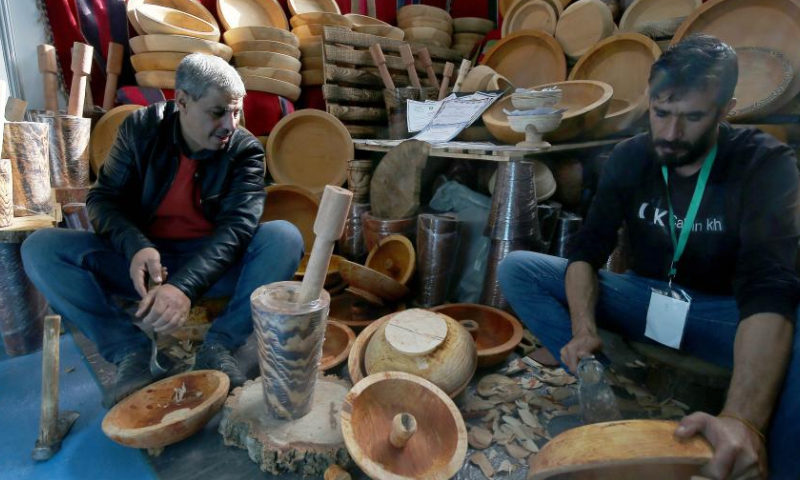 Exhibitors make handicrafts during the 23rd international handicrafts fair in Algiers, Algeria, on Nov. 24, 2022. (Xinhua)