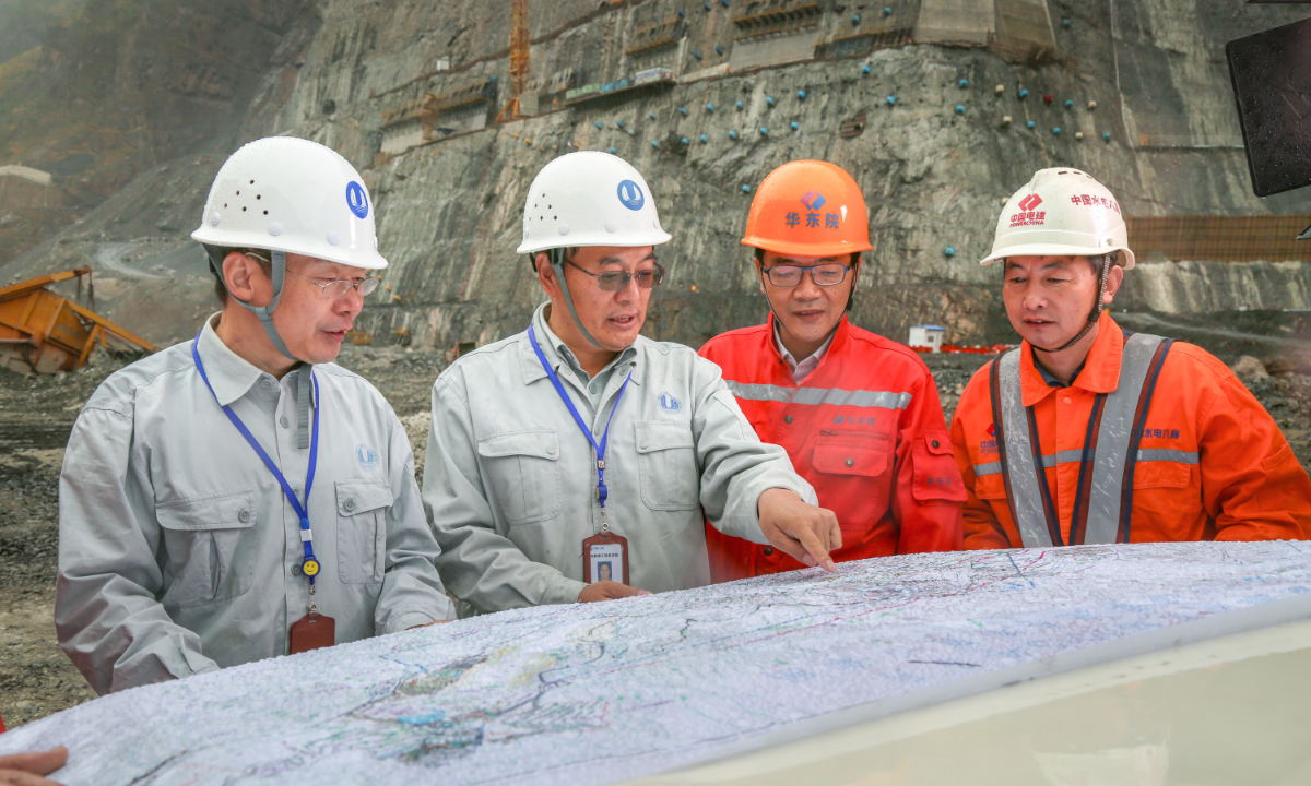 Wang Zhilin (second from left) and people in charge of the design and construction units inspect the Baihetan hydropower station construction site. Photo: Courtesy of China Three Gorges Corporation