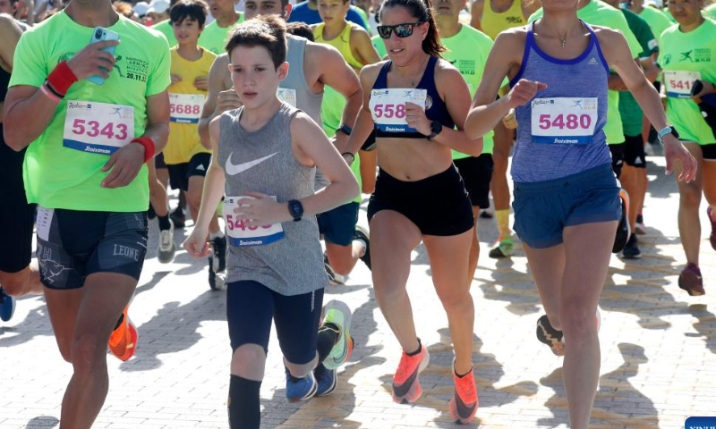 Participants run during the Larnaca International Marathon in Larnaca, Cyprus, Nov. 20, 2022. (Photo by George Christophorou/Xinhua)