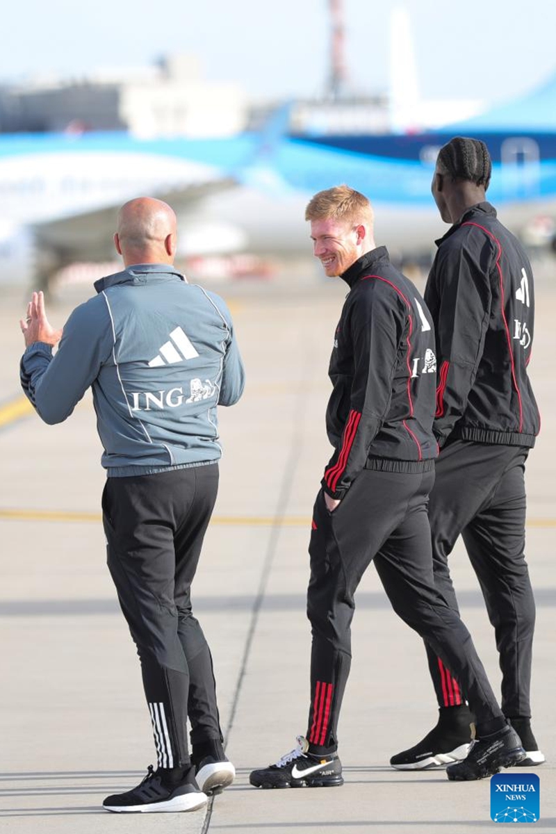 Kevin De Bruyne (C) of Team Belgium and head coach Roberto Martinez (L) are seen at the Brussels Airport in Zaventem, Belgium, Nov. 15, 2022. Team Belgium started their journey to the Middle East as they prepare for the upcoming Qatar 2022 World Cup. (Xinhua/Zheng Huansong)