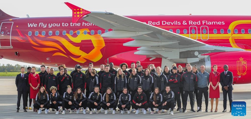 Members of Belgian national men and women football teams and the Brussels Airlines pose for photos with the new Trident airplane at the Brussels Airport in Zaventem, Belgium, Nov. 15, 2022. (Xinhua/Zheng Huansong)