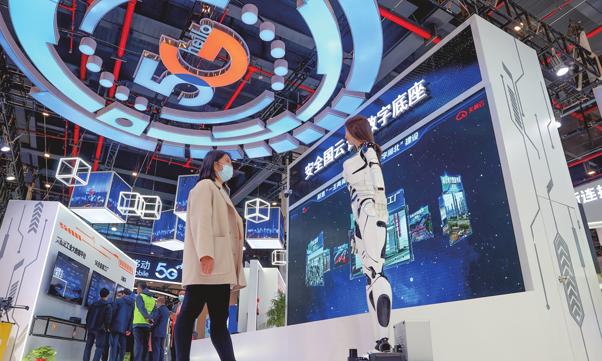 A visitor interacts with a humanoid robot at the China 5G+ Industrial Internet Conference in Wuhan, Central China's Hubei Province on November 20, 2022. China has more than 4,000 