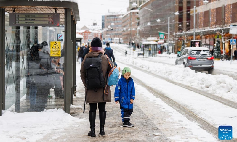 People wait for buses at a bus station in Stockholm, Sweden on Nov. 21, 2022. (Photo by Wei Xuechao/Xinhua)