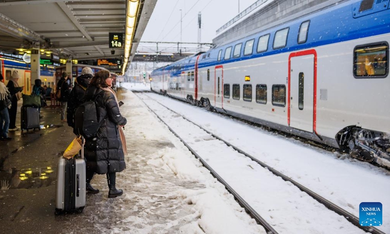 Travelers wait for trains on a platform in Stockholm's Central Station, Sweden on Nov. 21, 2022. (Photo by Wei Xuechao/Xinhua)