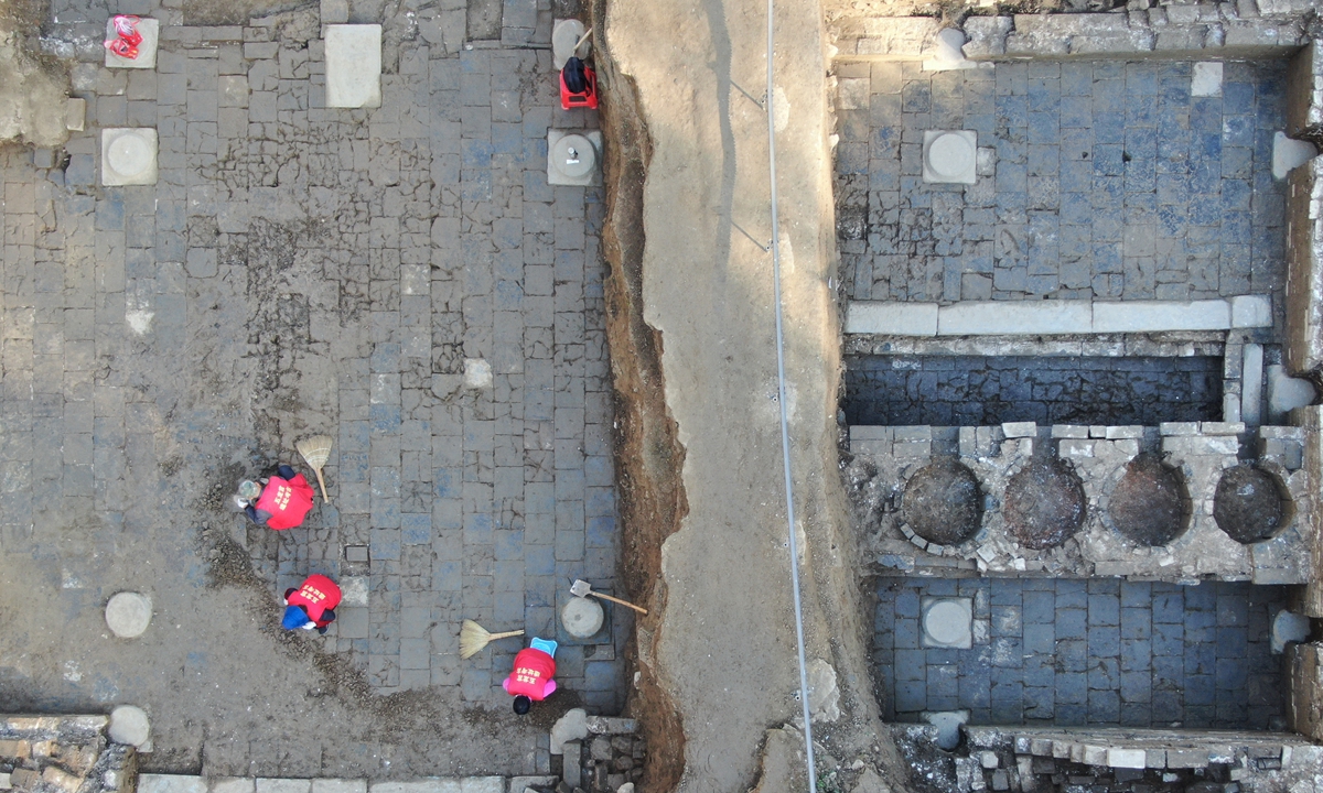 Archaeologists clean up the excavation site at the Wulong Palace at Wudang Mountains in Central China's Hubei Province. Photo: VCG