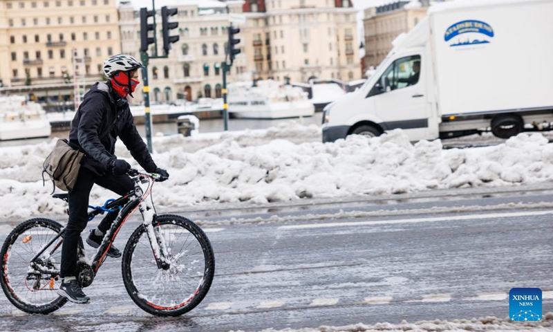 A citizen rides bicycle on a road in Stockholm, Sweden on Nov. 21, 2022. (Photo by Wei Xuechao/Xinhua)