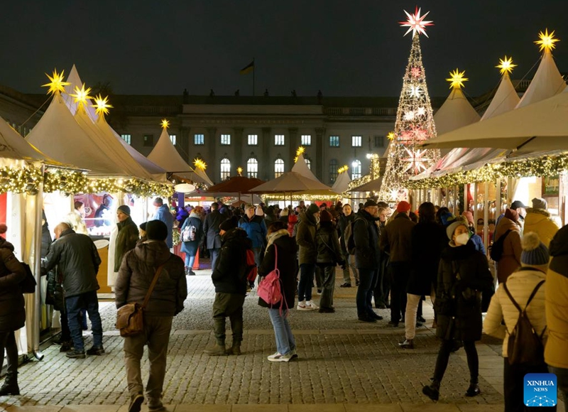 People visit the Christmas market in front of the Berlin State Opera in Berlin, Germany, Nov. 22, 2022. (Photo by Stefan Zeitz/Xinhua)