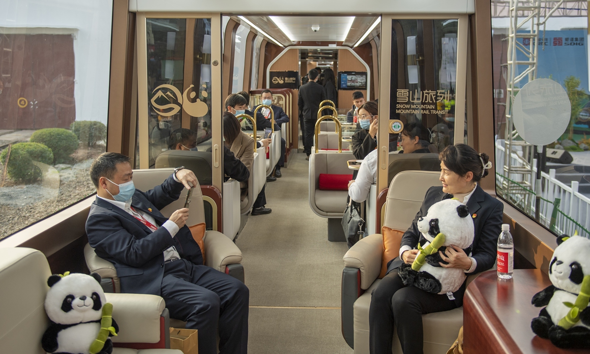 People take pictures on China's first cog/rail train with independent IPR, as it rolls off the production line in Ziyang, Southwest China's Sichuan Province on November 24, 2022. The train is suitable for sightseeing routes in mountainous areas. The maximum speed on the wheel-rail section can reach 120 km/h, and 40 km/h on the cog-rail. Photo: cnsphoto