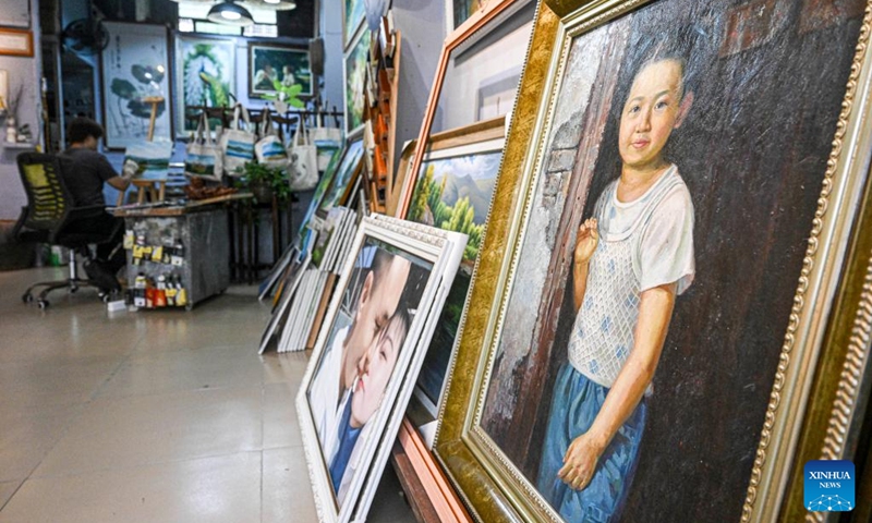 This photo taken on Nov. 21, 2022 shows oil paintings at a gallery on the oil painting street of Tunchang County, south China's Hainan Province. Tunchang County boasts oil painting as its characteristic industry. The annual production value of Tunchang oil paintings reaches about 7,000,000 RMB (977,000 U.S. dollars). (Xinhua/Pu Xiaoxu)