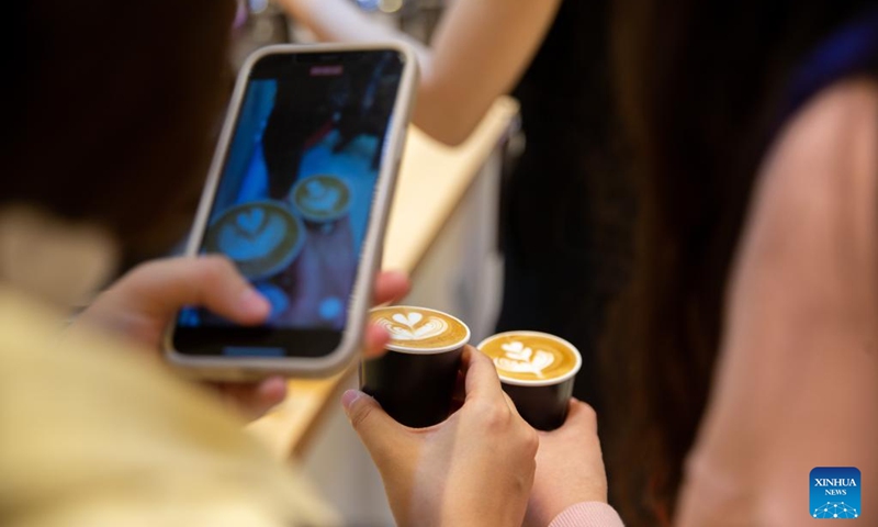 Visitors take photos during the 2022 Seoul International Cafe Show in Seoul, South Korea, Nov. 23, 2022. The 2022 Seoul International Cafe Show kicked off in Seoul on Wednesday. (Xinhua/Wang Yiliang)