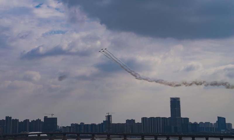 Aircrafts from a South African aerobatics team leave trails of smoke when performing above downtown Nanchang, capital of east China's Jiangxi Province, Nov. 23, 2022. (Xinhua/Zhou Mi)