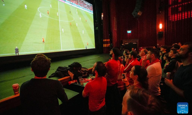 People watch the live broadcast of a Group F match between Canada and Belgium at the 2022 FIFA World Cup, inside a cinema in Vancouver, British Columbia, Canada, on Nov. 23, 2022. (Photo by Liang Sen/Xinhua)