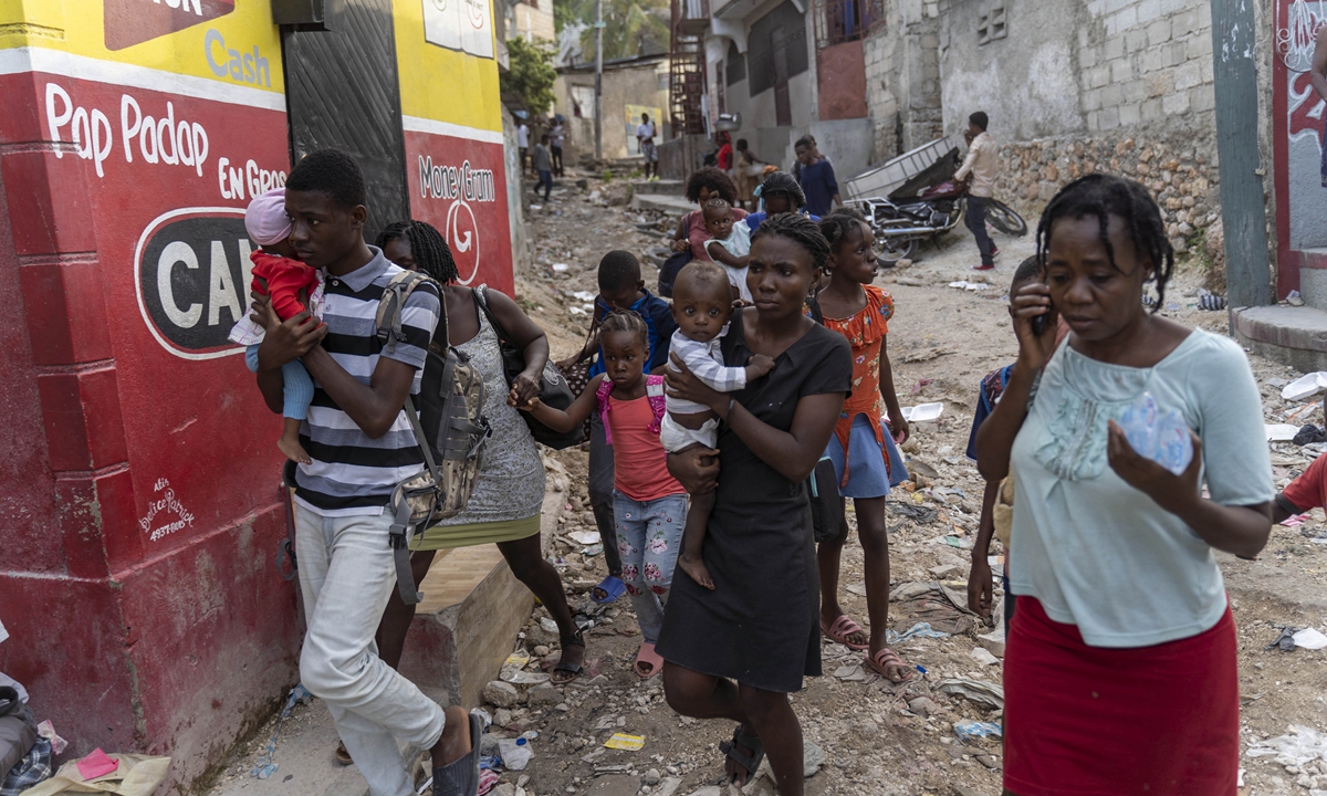 People flee their homes during an attack by armed gangs in the Carrefour Feuille neighborhood of Port-au-Prince, Haiti on November 10, 2022. Photo: AFP