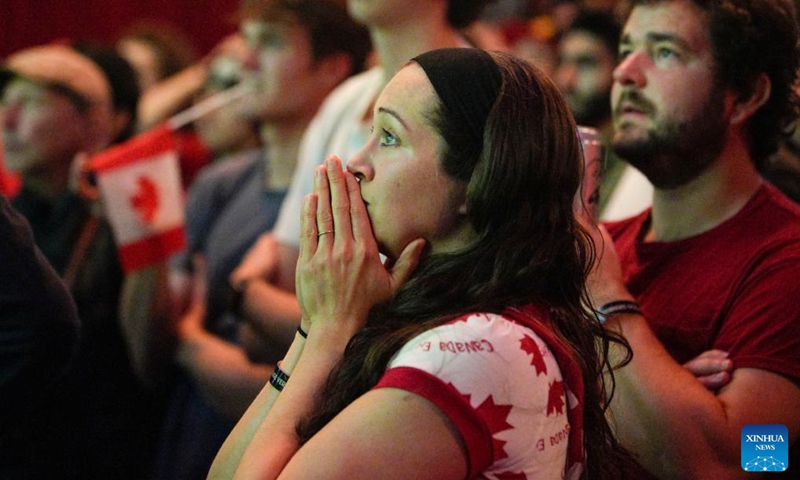 People watch the live broadcast of a Group F match between Canada and Belgium at the 2022 FIFA World Cup, inside a cinema in Vancouver, British Columbia, Canada, on Nov. 23, 2022. (Photo by Liang Sen/Xinhua)